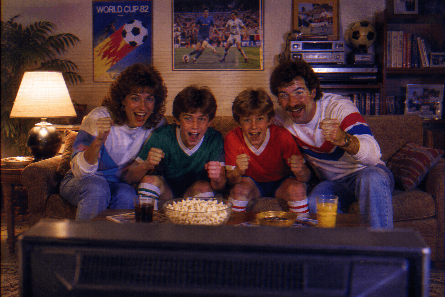 Children watching football on television